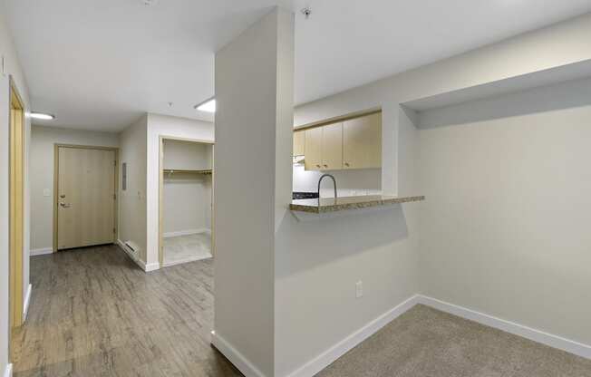 Living Room View with Breakfast Bar and Plank Flooring at Excalibur Apartment Homes, Washington, 98004
