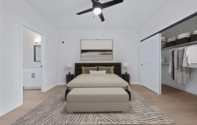 a bedroom with a bed and a ceiling fan