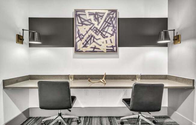 A modern office with a large abstract painting on the wall.