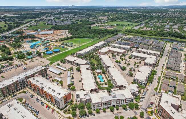 an aerial view of a city with buildings and a pool