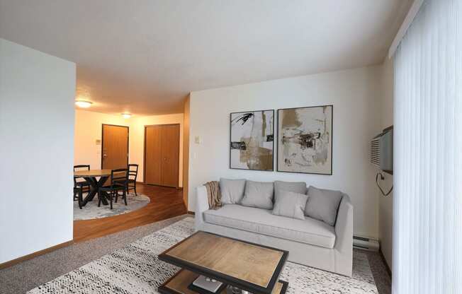 Fargo, ND Flagstone Apartments. a living room with a couch and a coffee table