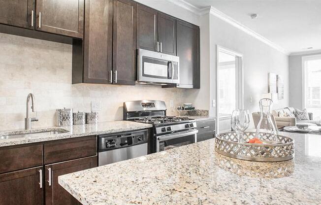 a kitchen with granite counter tops and stainless steel appliances