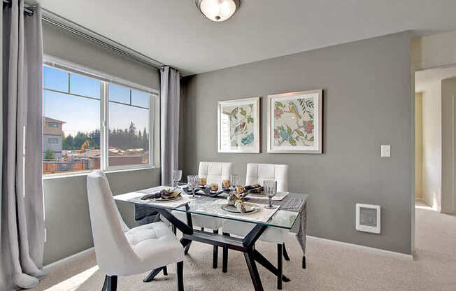 A dining room with a table set for two and a view of the city. at Mill Creek Meadows Apartments, Washington