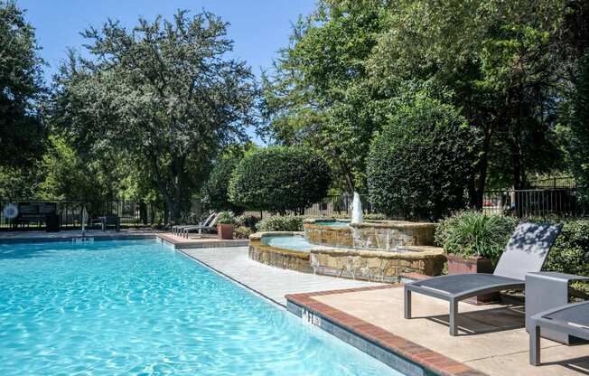 luxury swimming pool with a fountain at Stoneleigh on Spring Creek apartments