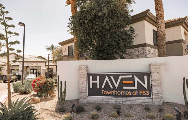 A sign for Haven Townhomes at P83 is displayed in front of a building.