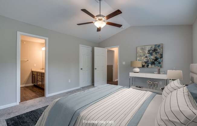 a bedroom with a large bed and a ceiling fan