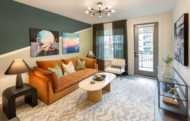 a living room with a orange couch and a coffee table