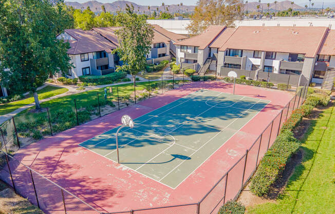 a basketball court in a neighborhood with houses