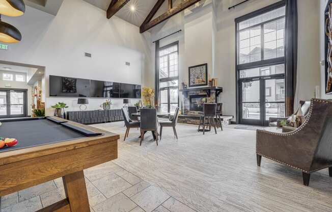 a game room with a pool table and a bar