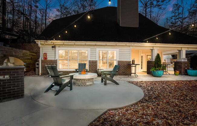 a circular concrete patio with a fire pit in the middle