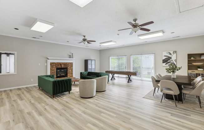 a living room with a fireplace and a table with chairs