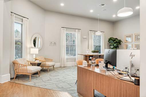 A modern home office with a wooden desk and a chair.
