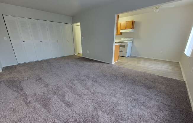 Spacious living room and dining room at Garfield Commons Apartments in Clinton Township, MI