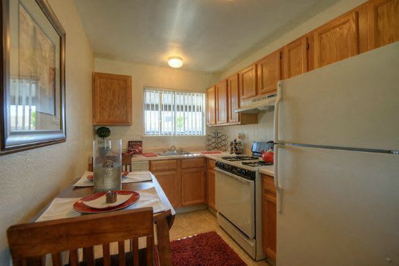  Kitchen with Hardwood Inspired Floors, Wood Chairs, Refrigerator, Windows and Wood Cabinets