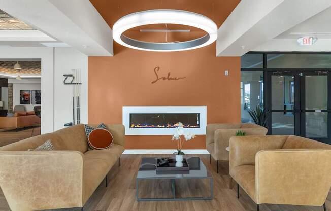 A living room with a fireplace and a chandelier.