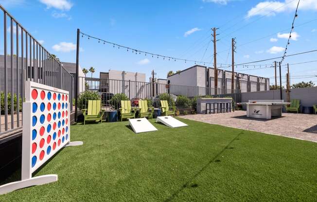 a backyard with lawn games and a ping pong table