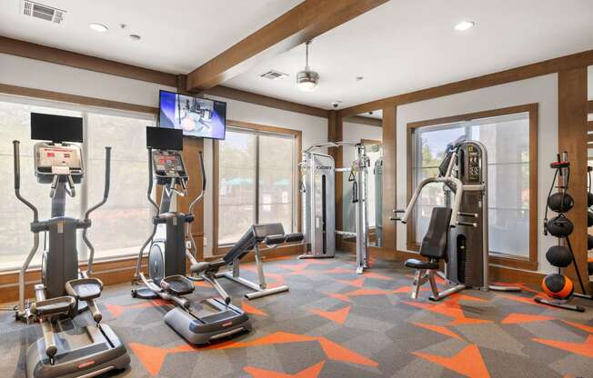 a home gym with exercise equipment and windows
