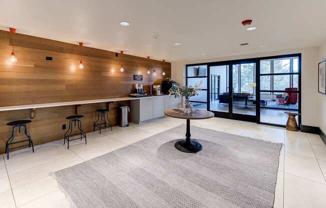 a living room with a bar and a kitchen with glass doors at Ashford Belmar Apartments, Lakewood