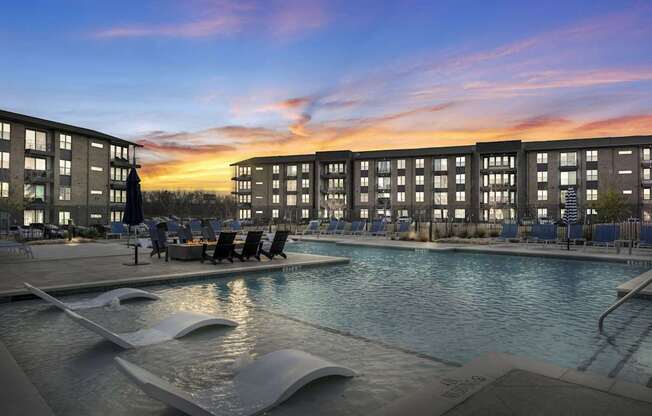 A modern pool area with a large rectangular pool and a smaller wavy pool next to it.