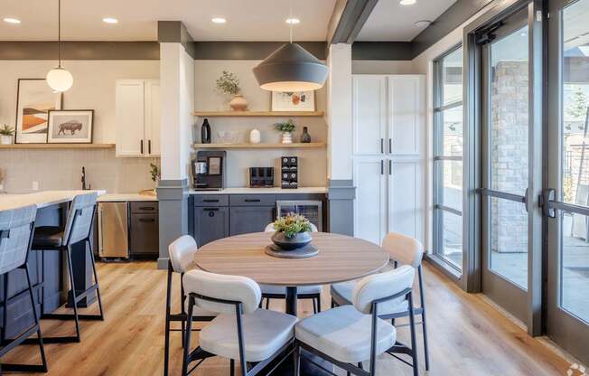 A modern kitchen with a dining table set for four.