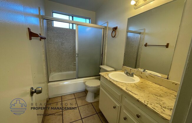 a bathroom with a sink and a toilet and a shower