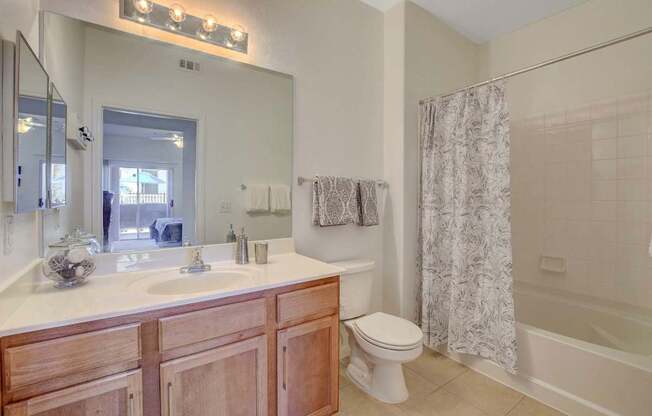 A bathroom with a sink, toilet, and shower.