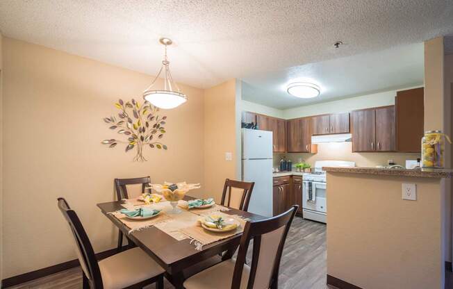 A dining room with a table set for a meal at Sterling Point Apartment Homes, Phoenix