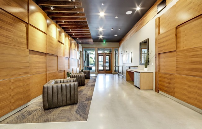 The Hayes on Stone Way Apartments large lobby with wood paneling and seating and a counter at The Hayes on Stone Way, Seattle, WA, 98103