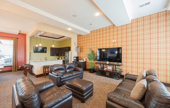 a living room with leather furniture and a television