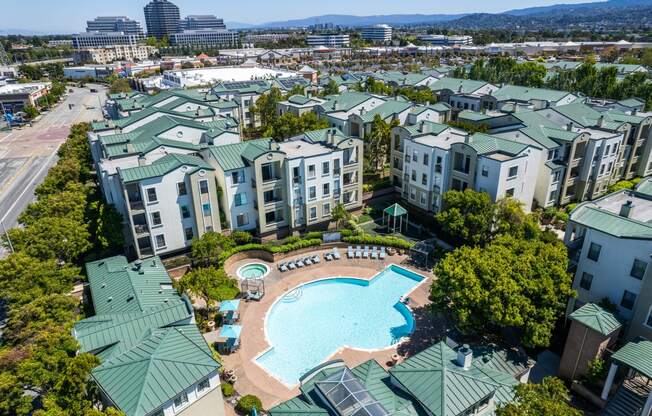 an aerial view of a swimming pool in the middle of an apartment complex