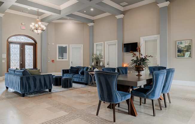 a dining room and living room with blue chairs and a table