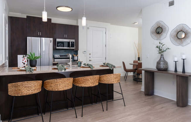 A kitchen with brown cabinets and a white fridge.