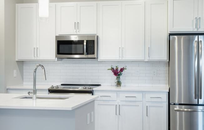 White counter top, cabinets in kitchen area at Icon Apartment Homes at Ferguson Farm, Montana