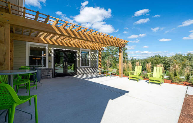 a patio with a pergola and chairs at Edgebrook Residences, Merrimack