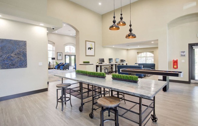 a communal area with a ping pong table and chairs