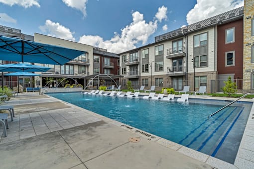 A swimming pool surrounded by apartment buildings.