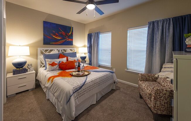 Two Bedroom Apartments in Myrtle Beach SC - Lattitude @ The Commons - Bedroom With a Ceiling Fan, Plush Carpeting, and Large Windows