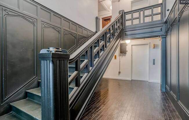A staircase with a metal railing and wooden steps.