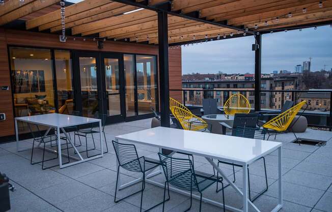 A patio with a table and chairs is set up on a rooftop.