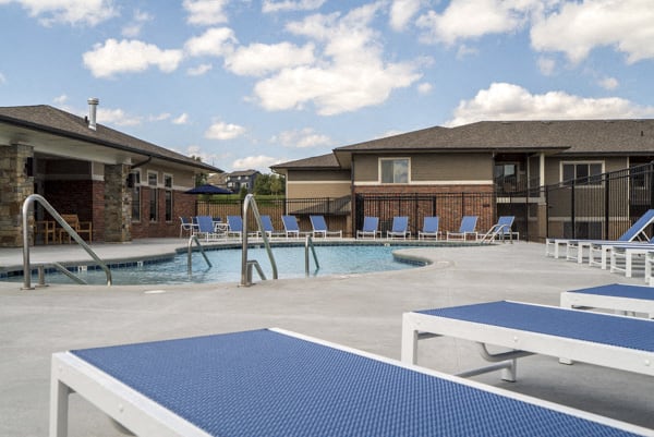 Resort-style pool with lounge seating at The Villas at Falling Waters townhomes in west Omaha, NE