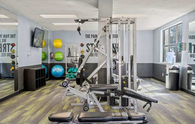 A gym with a variety of equipment including a leg press machine.