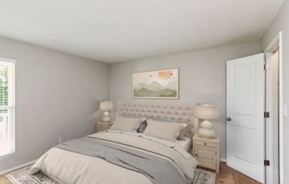 Bedroom with a Large Bed at Woodcreek Apartments, Cary, 27511