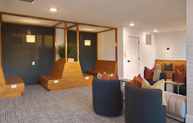a living room with couches and chairs and a staircase