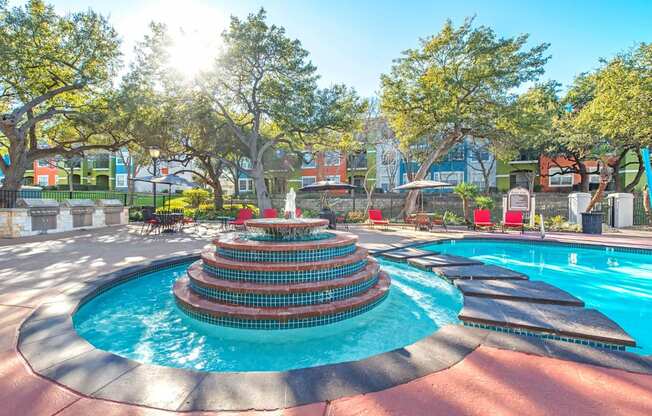 A pool with a fountain in the middle of it at Reserve at Canyon Creek,Texas
