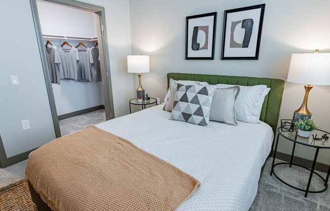 Bedroom With Bed, Carpet Flooring, Two Nightstands With Lamps, Modern Decor, Dresser, And Two Windows. at Bayswater Apartments, Burlingame, 94010