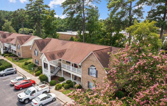 an aerial view of an apartment complex with cars parked in a parking lot