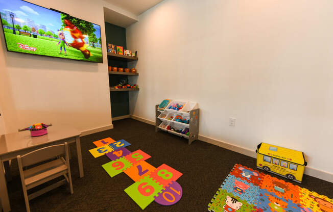 a childs play room with toys and a television at Pinnacle Apartments, Florida, 32256