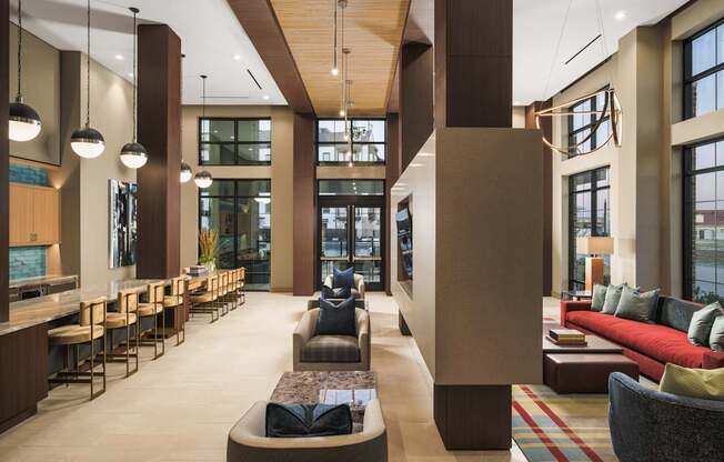 A modern living room with a long couch and a bar area.