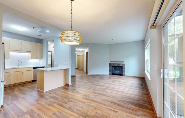 A modern kitchen with wooden floors and a large island.