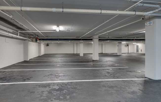 a empty parking garage with white walls and white pillars